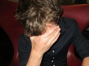 Frustrated player with his head in his hands