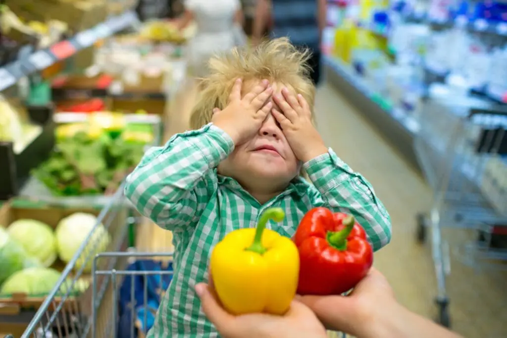Meme competition example: child hiding behind vegetables