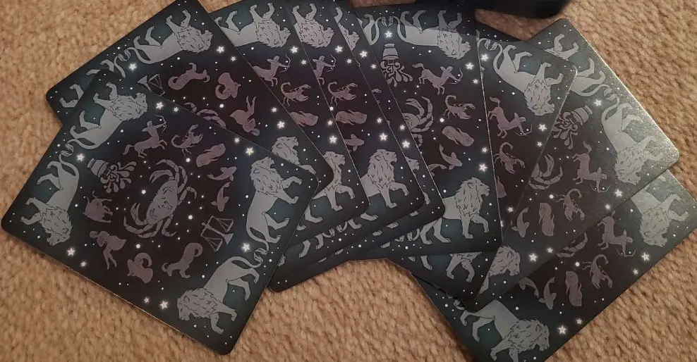 Constellation playing cards spread on a carpet