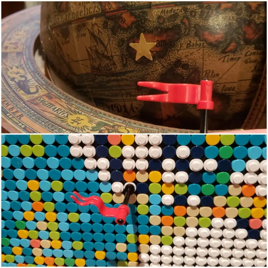 Globe with a gold star, and a red flag pin on a world map made of LEGO dots