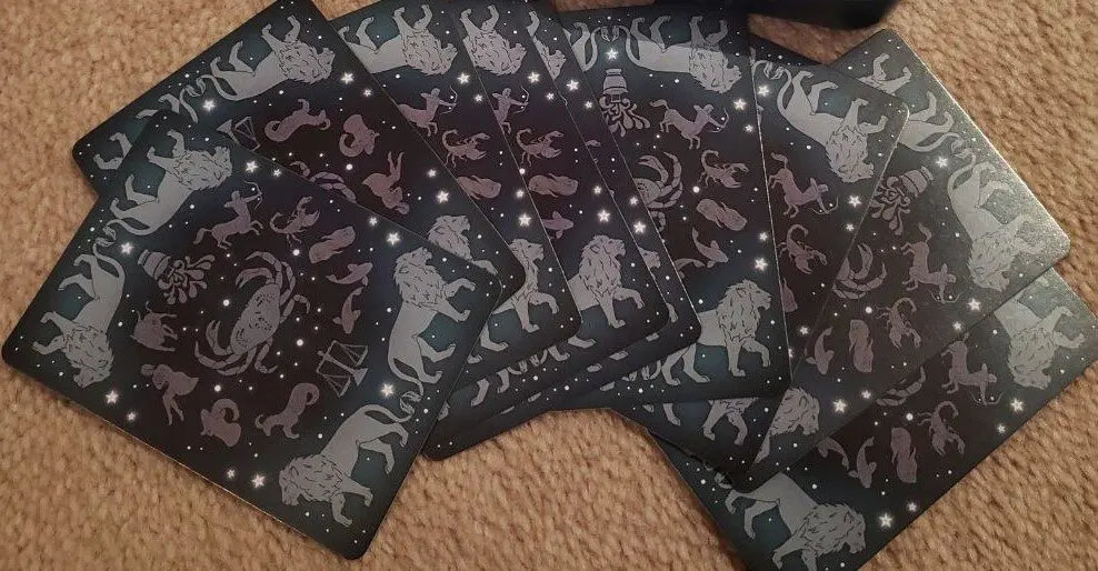 Constellation playing cards spread on a carpet