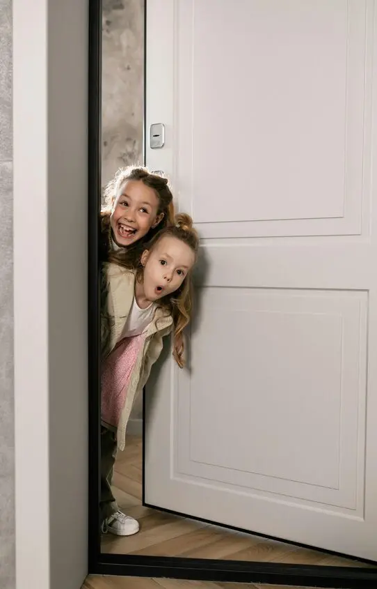 Child peeking around a doorway