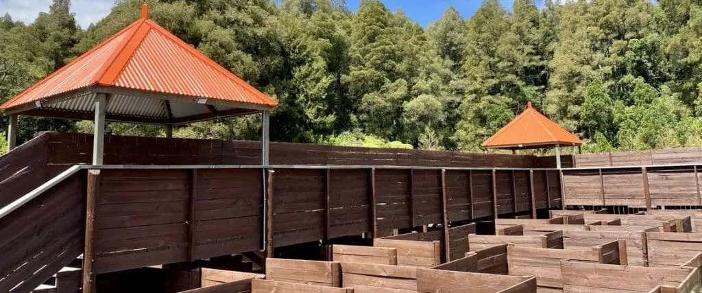 Outdoor escape game area with wooden huts