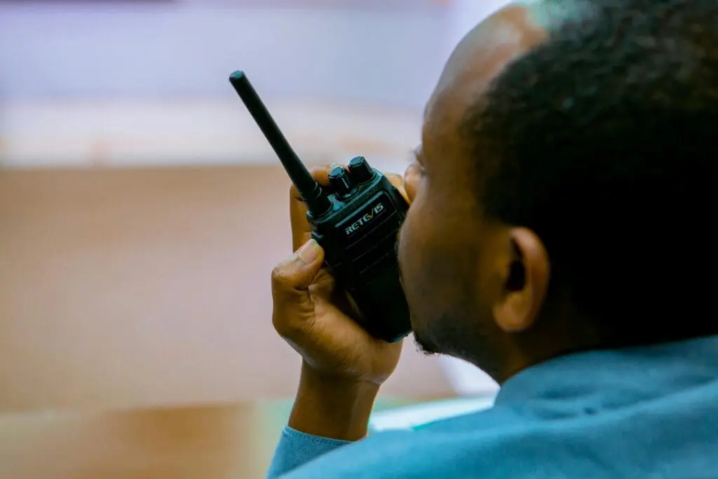 Person speaking into a walkie-talkie