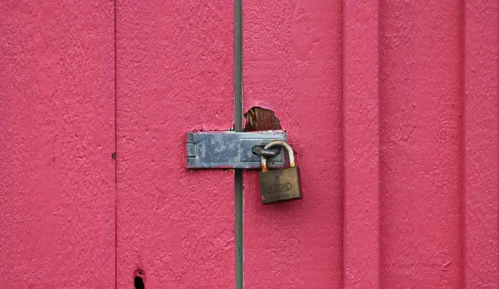 Padlock on a pink door