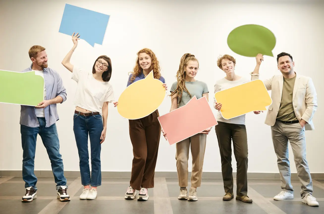 Team holding up speech bubbles