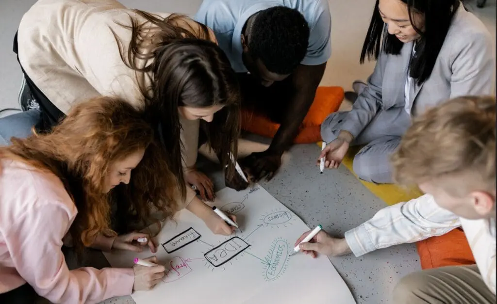 Team drawing together at a table