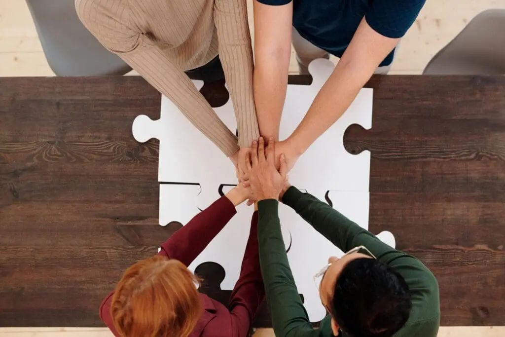 Team stacking their hands together